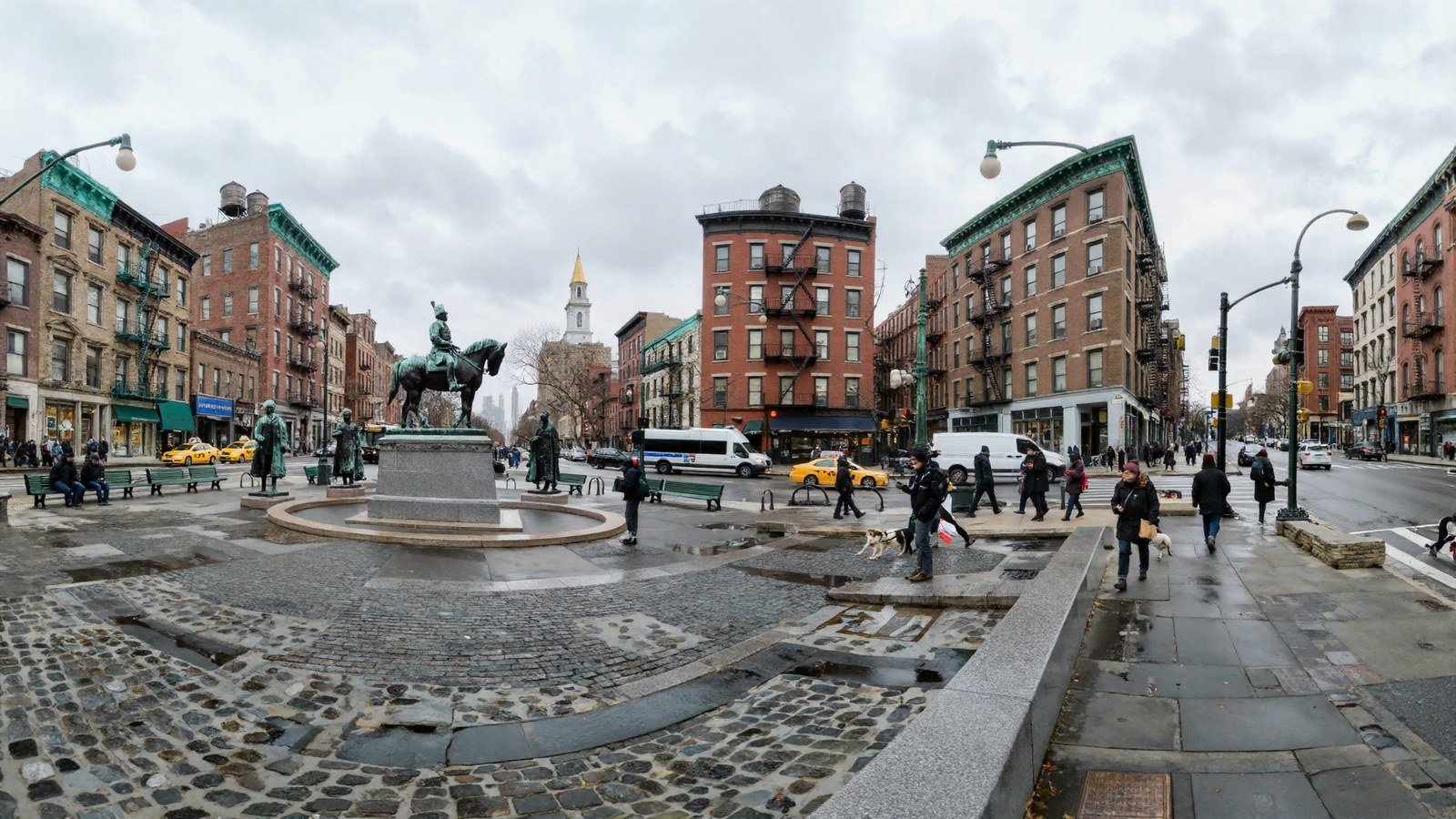 A wet New York plaza with an equestrian bronze on a granite plinth, brick buildings with fire escapes on both sides, and a road with taxis and a bus running away up the middle of the frame toward a distant white bell tower