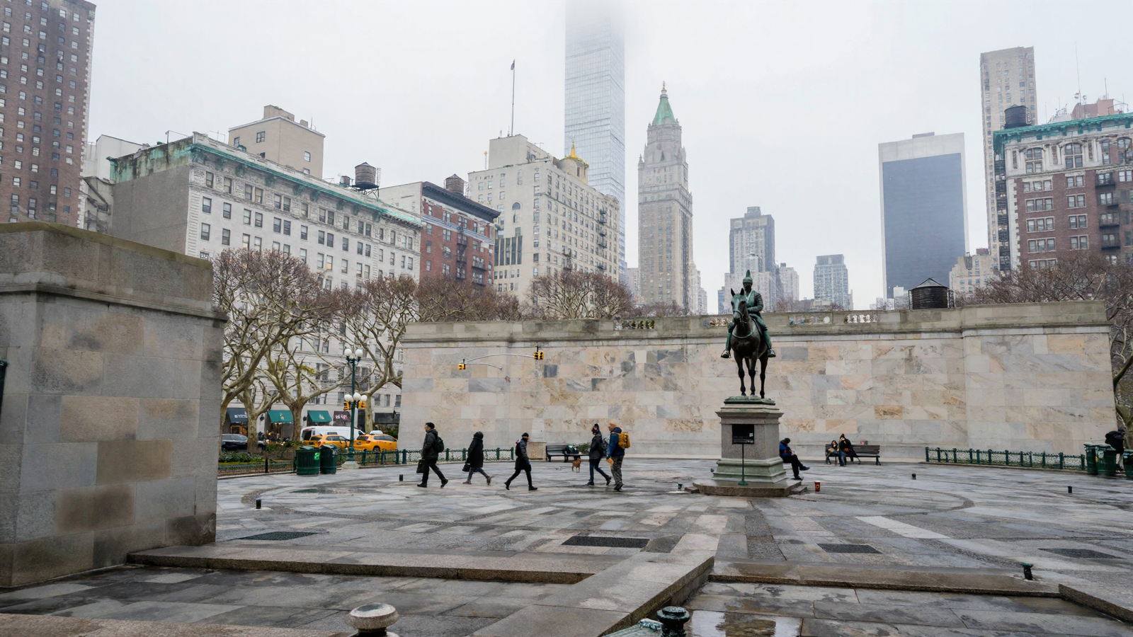 A photorealistic overcast view across Union Square in which six pedestrians in dark winter coats cross the wet granite plaza mid-stride, one carrying a yellow pack, a small dog on a lead beside them, two more people sitting on a bench at right and one seated at the base of the equestrian statue's plinth.